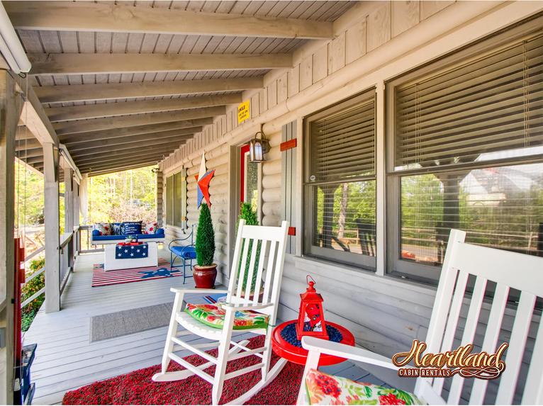 Wooden rocking chairs and porch swing